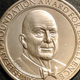 A golden James Beard Award Medallion against a black background